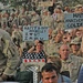 Soldiers hold up signs while waiting for Toby Keith