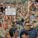 A Soldier holds up a sign while waiting for Toby Keith