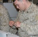 Cpl Harley Mason III repairs a damaged Dragon Eye