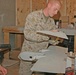 Sgt Patrick W. Broughal sands a damaged Dragon Eye