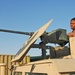 Spc. Groover checks a .50-cal machine gun before convoying