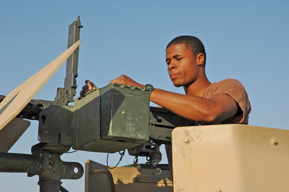 Spc. Groover checks a .50-cal machine gun before convoying