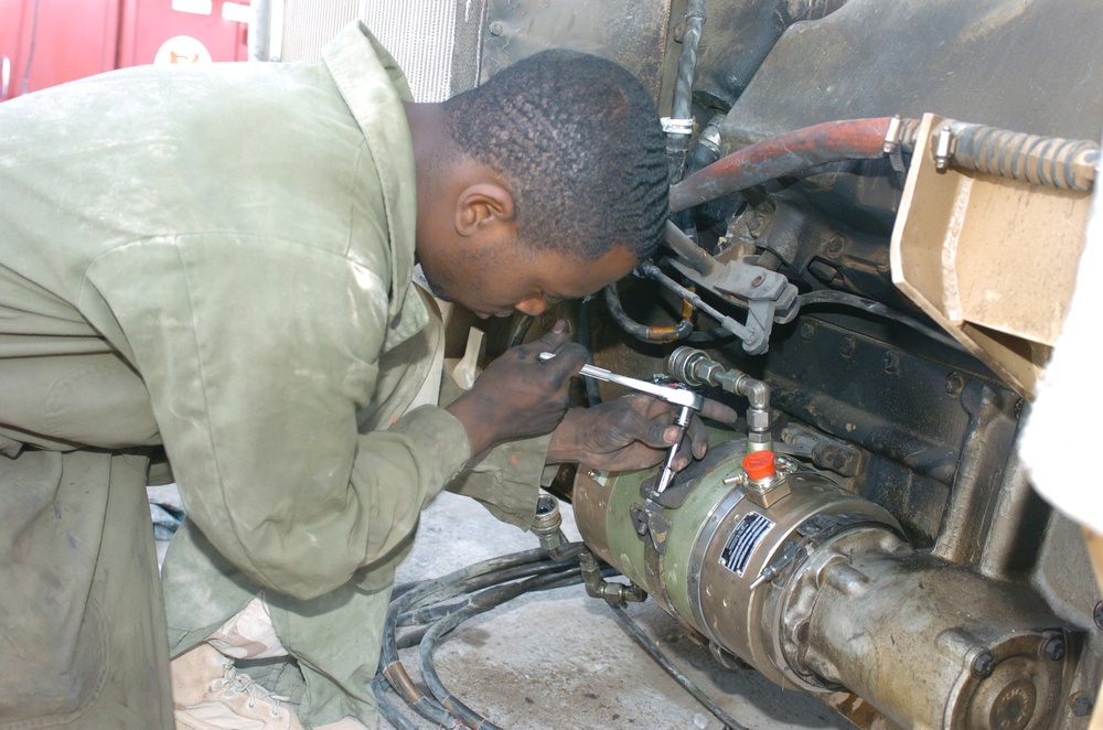 Spc. Dredatis Cook tightens the bolts on a generator