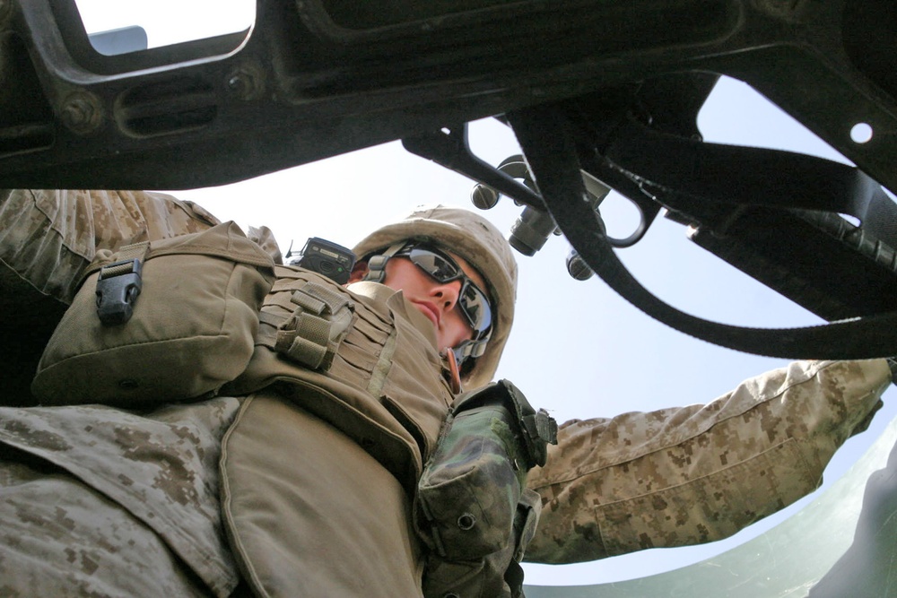 Cpl Matthew Labell mans a M2 .50 caliber machine gun
