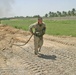 Lcpl. Bailey drags a chain used to move (T) barriers