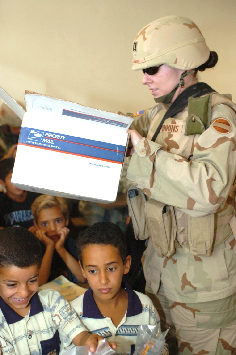 Capt. Adrian J. Crimmins passes out school supplies