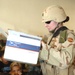 Capt. Adrian J. Crimmins passes out school supplies