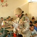 Capt. Adrian J. Crimmins passes out school supplies