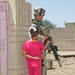 aA young Iraqi girl presents Sgt. Ford a single red rose