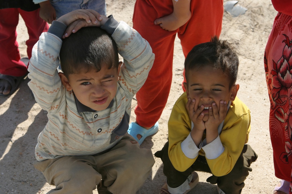 Two Iraqi boys stop to pose for the camera