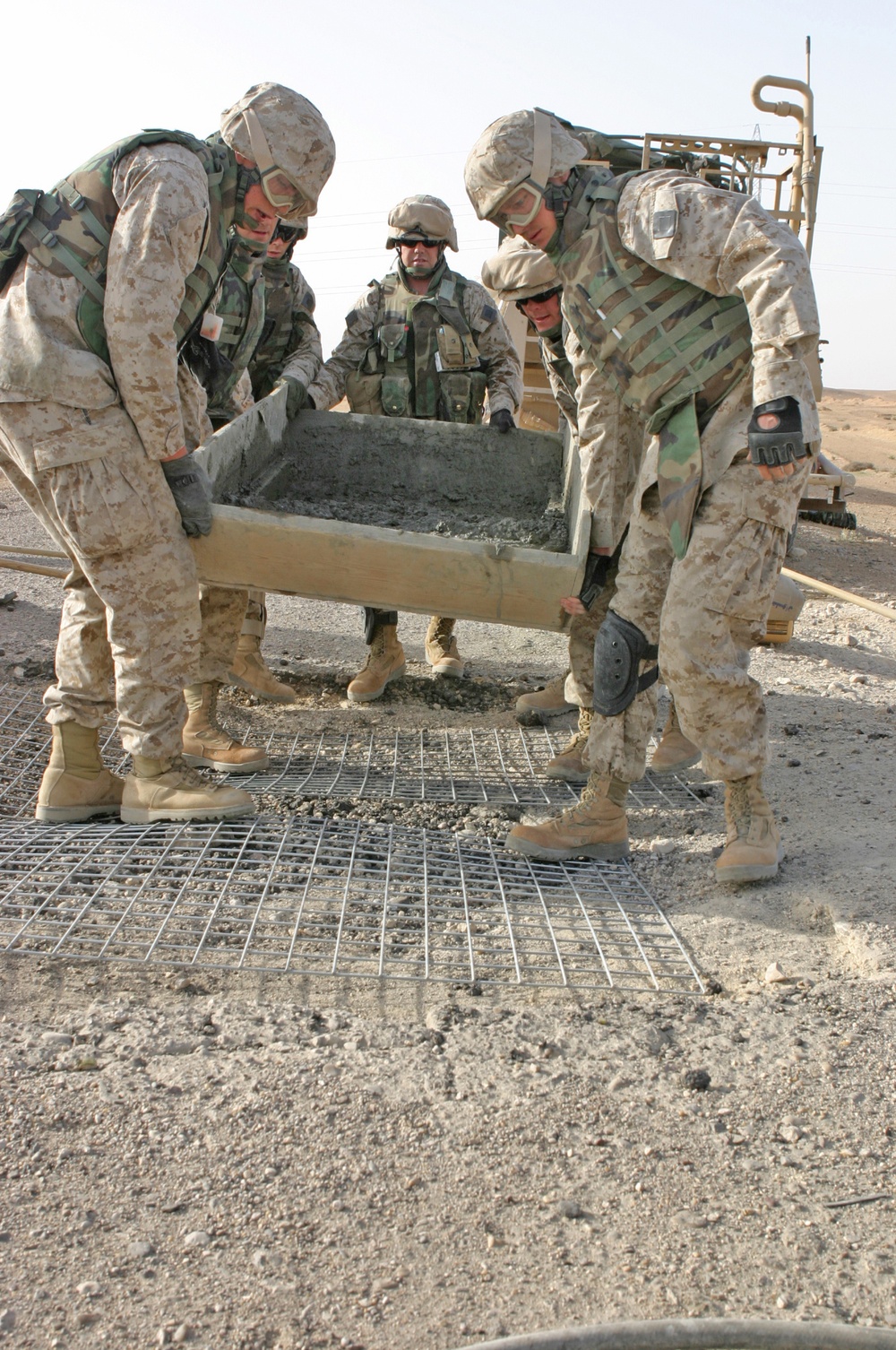 Marines pour concrete into a crater in Western Iraq recently