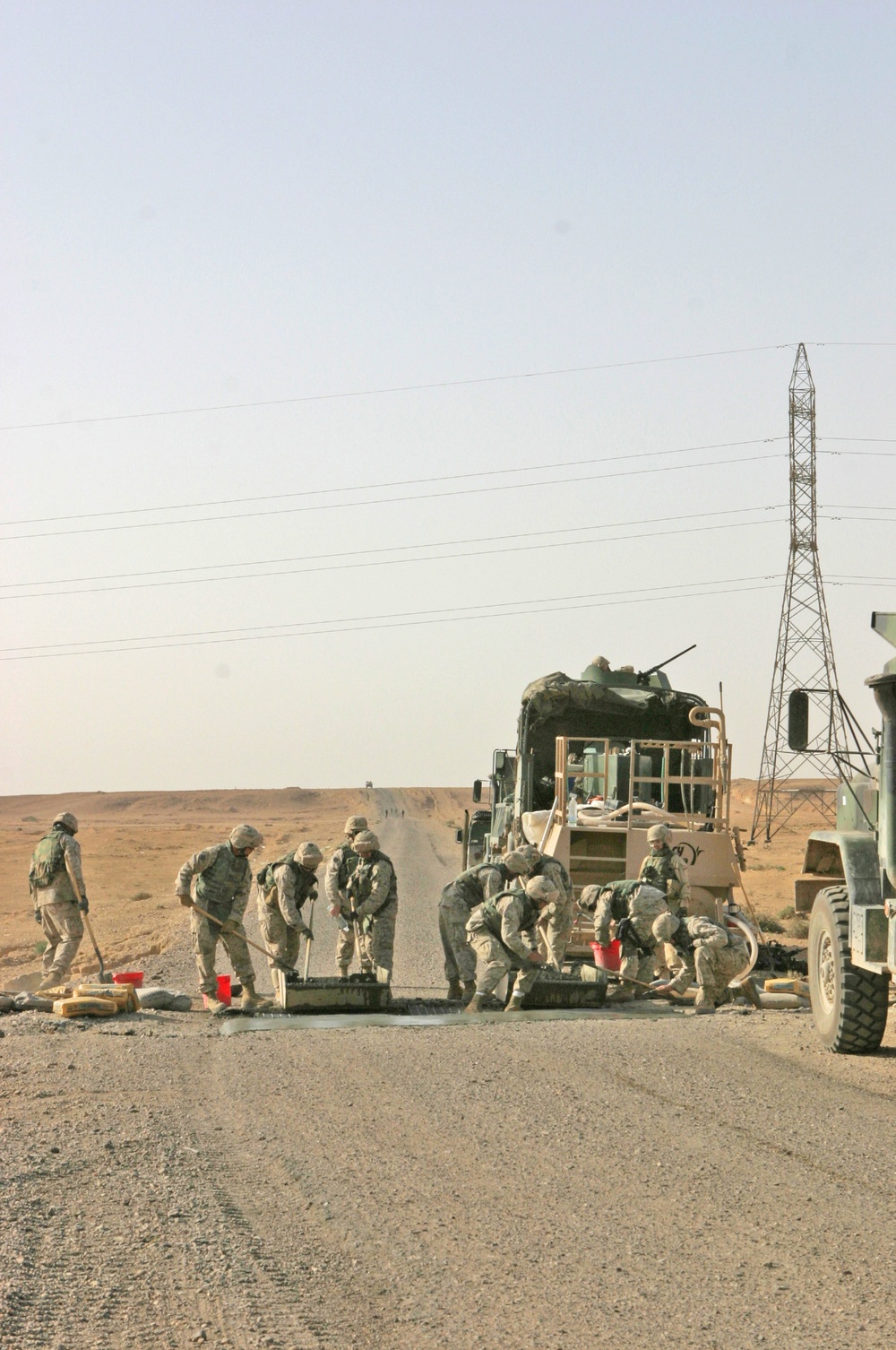 Marines repair a crater in a Western Iraqi road recently