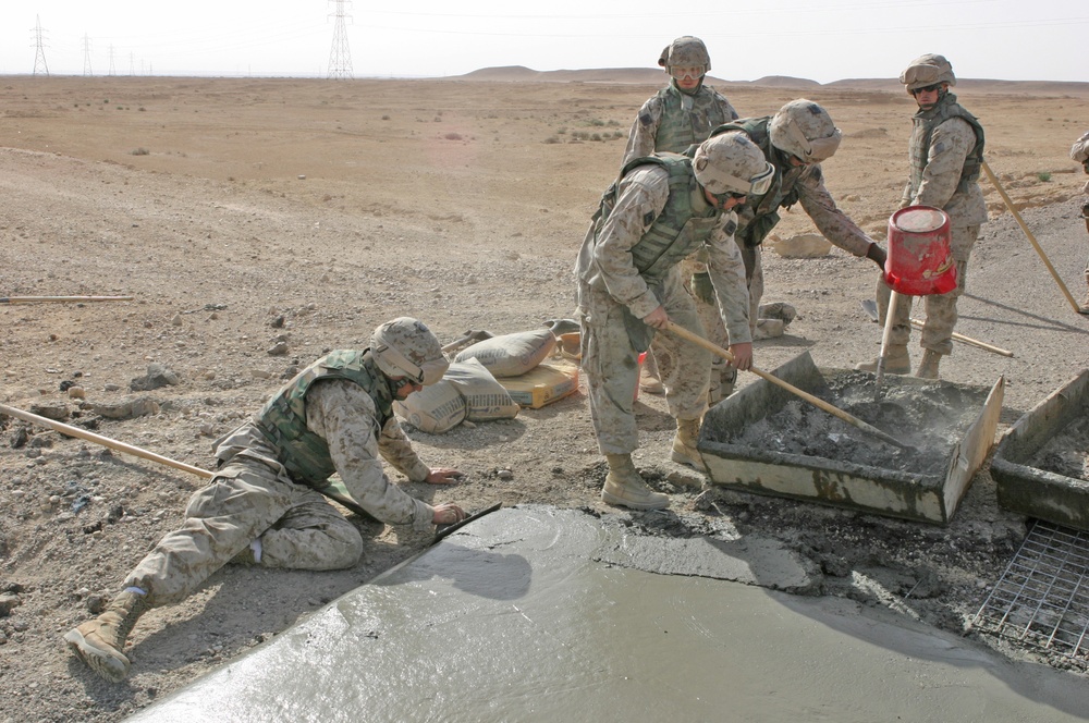 Marines repair a crater in a Western Iraqi road recently