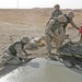 Marines repair a crater in a Western Iraqi road recently