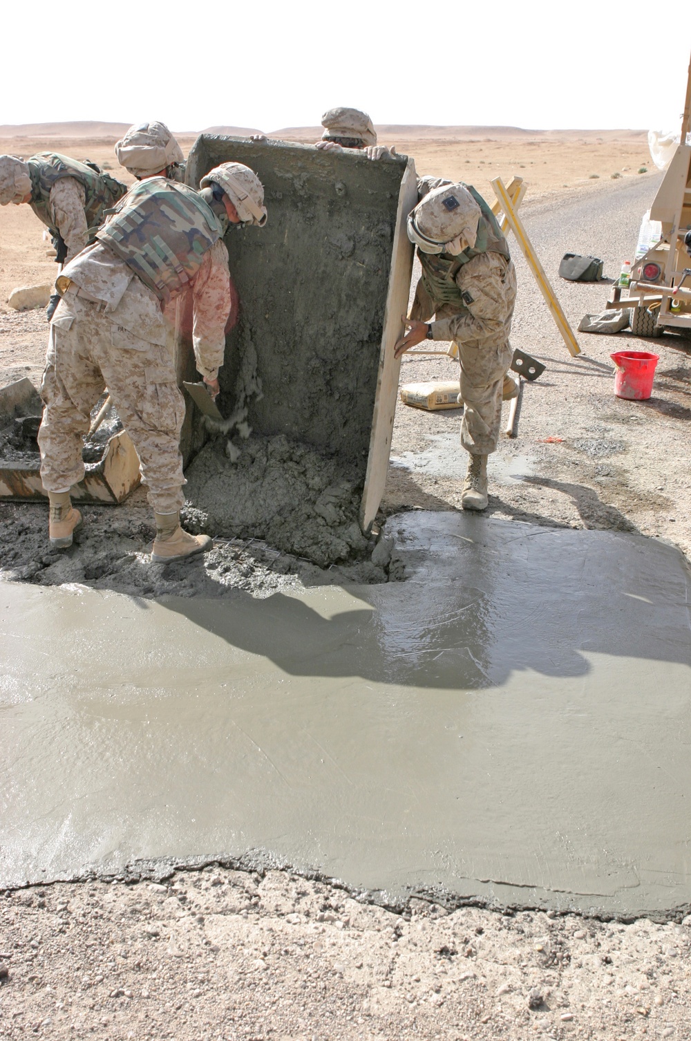 Marines pour concrete into a crater in Western Iraq recently