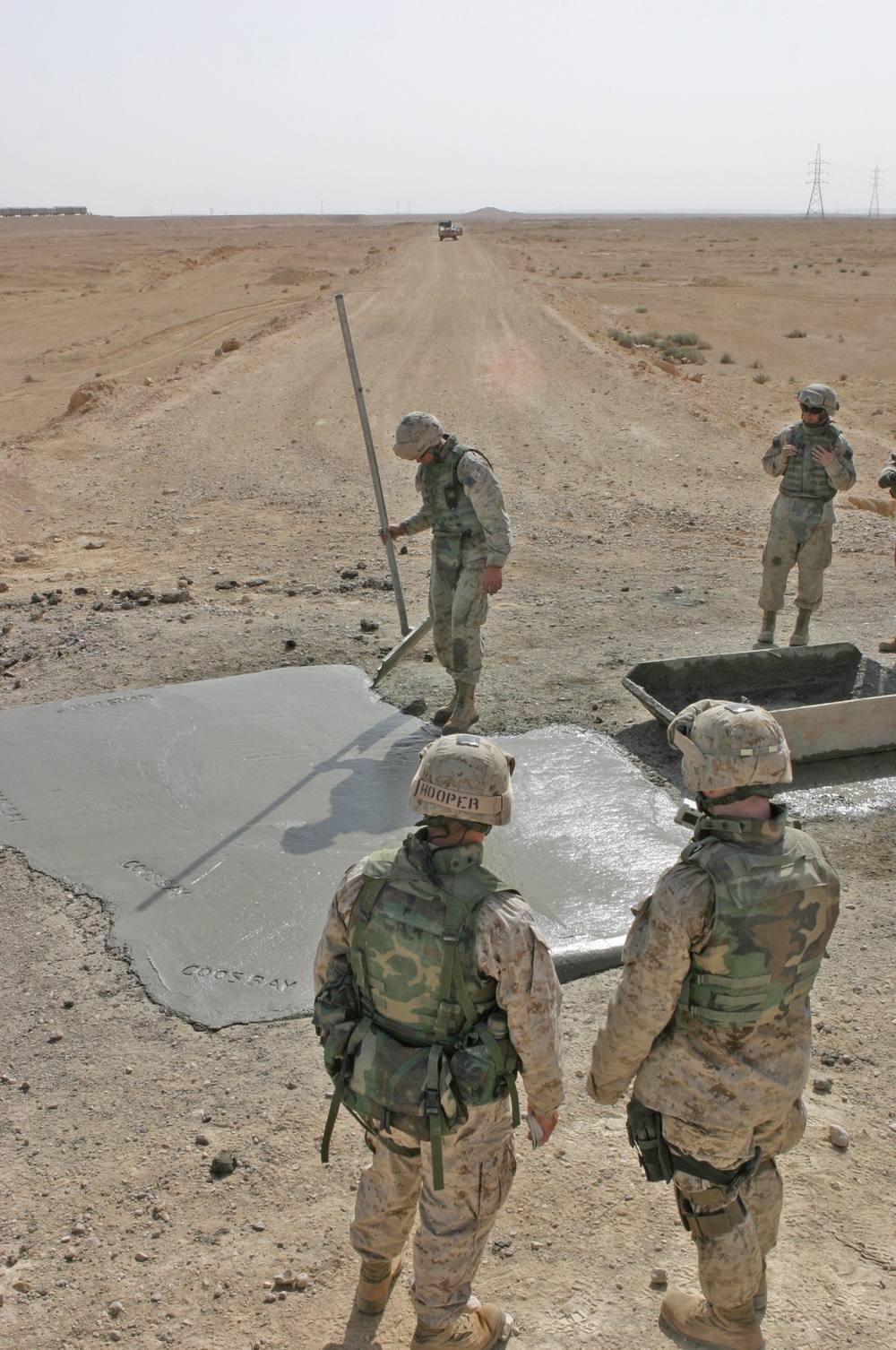 Marines inspect their work on a crater they repaired