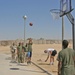 Sailors shoot hoops during a cookout and sporting day