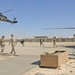 Sailors rush to an Army UH-60Q (Blackhawk) helicopter