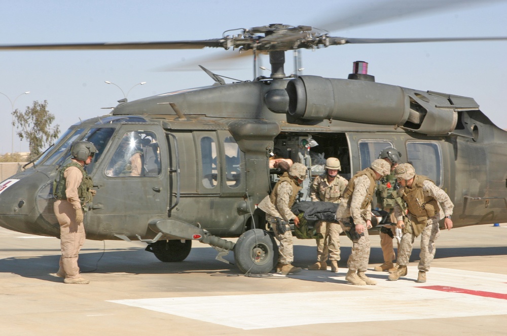 Sailors unload wounded Marines from an Army UH-60Q