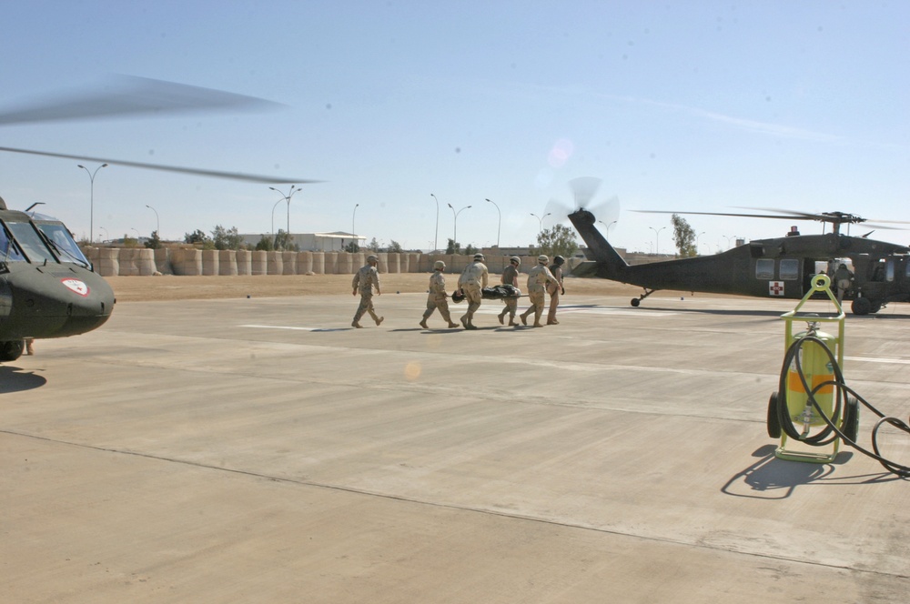Soldiers transport a wounded Marine to the Blackhawk