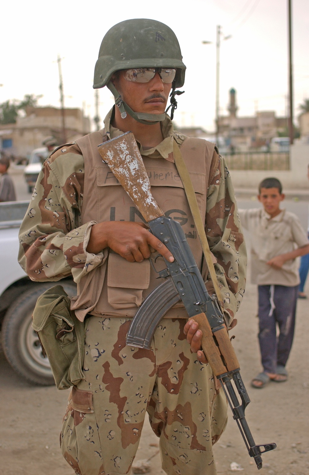 An Iraqi army soldier stands guard during a joint patrol