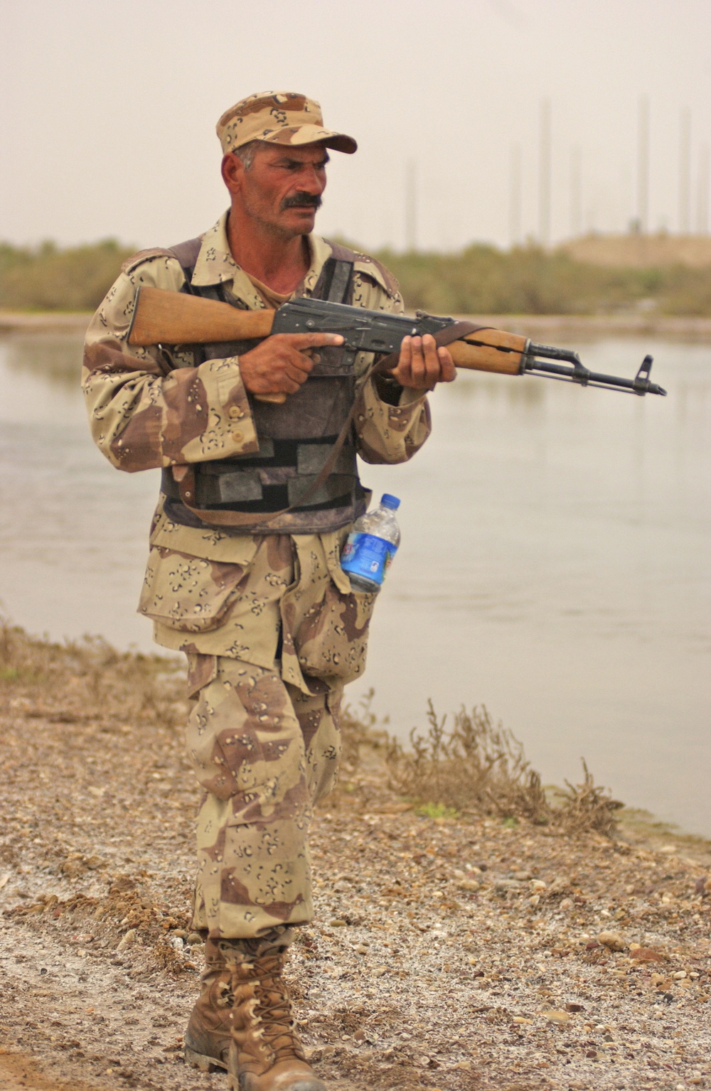 An Iraqi army soldier patrols through the streets