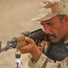 An Iraqi army soldiers keeps an eye out