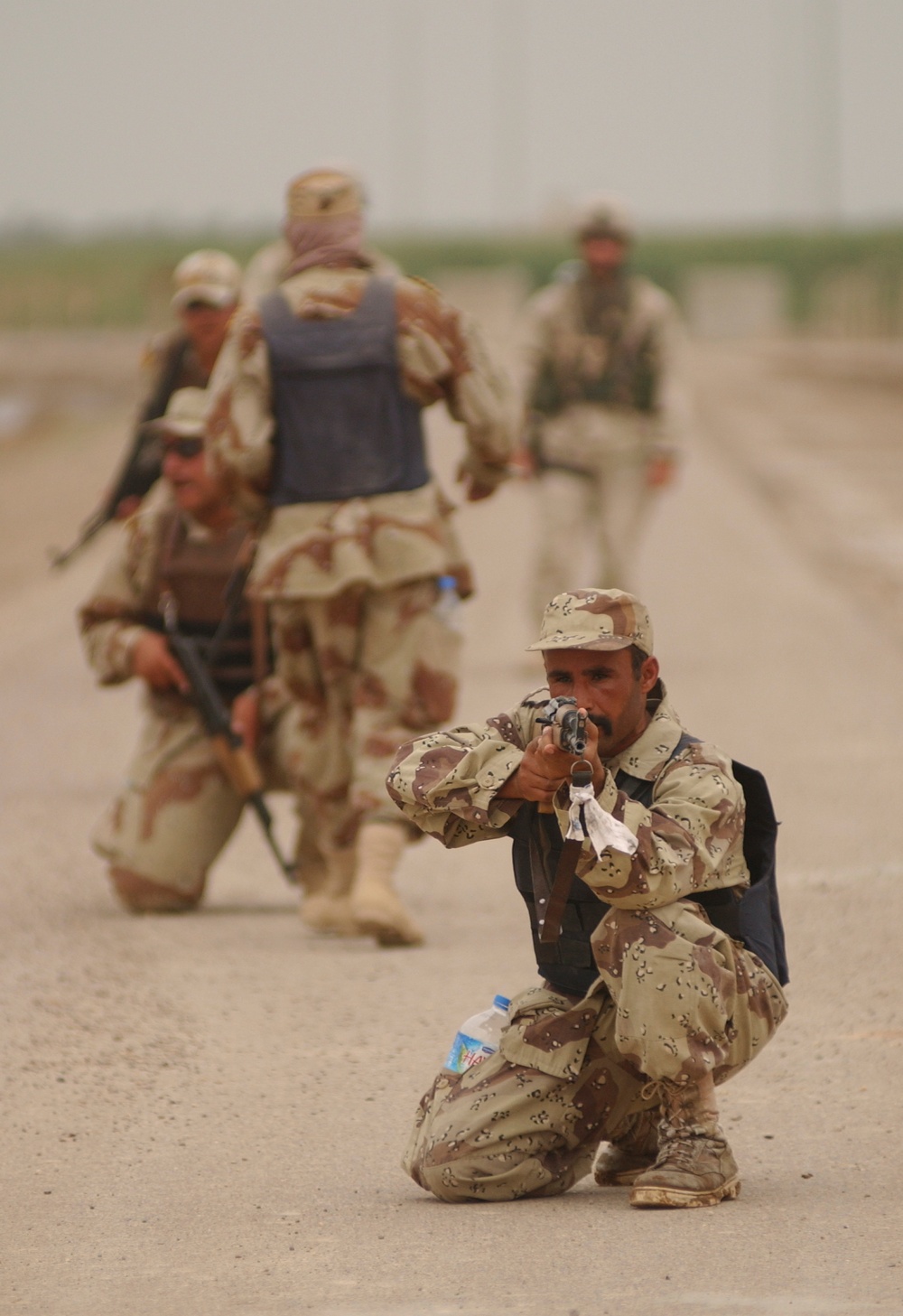 An Iraqi army soldier pulls security in in the street