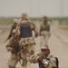 An Iraqi army soldier pulls security in in the street