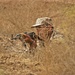 An Iraqi army soldier takes cover during a simulated