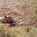 An Iraqi army soldier takes cover during a simulated fire fight