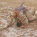 An Iraqi army soldier drangs a soldier to cover