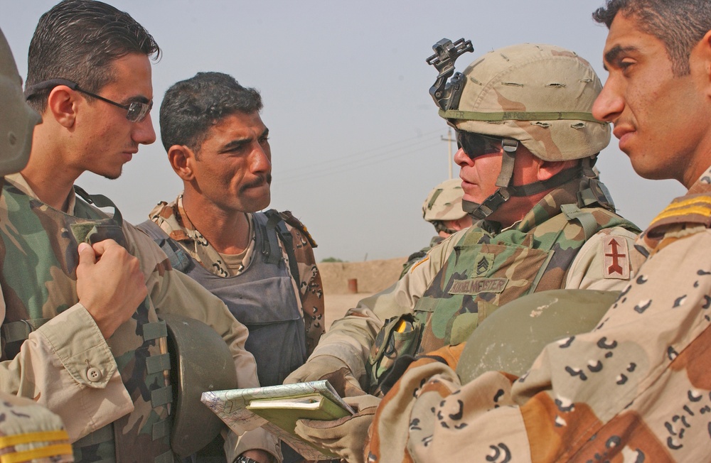 SFC Todd Kuchelmeister goes over a mission plan