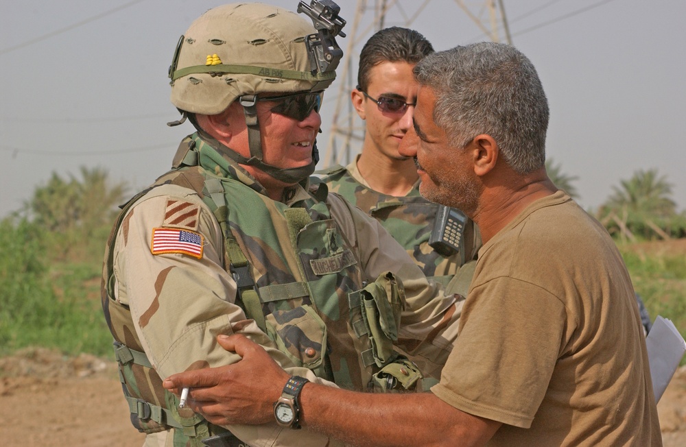 SFC Todd Kuchelmeister talks with a local Iraqi leader