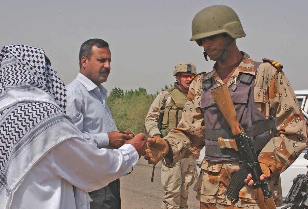 An Iraqi army soldier inspecting the indetification