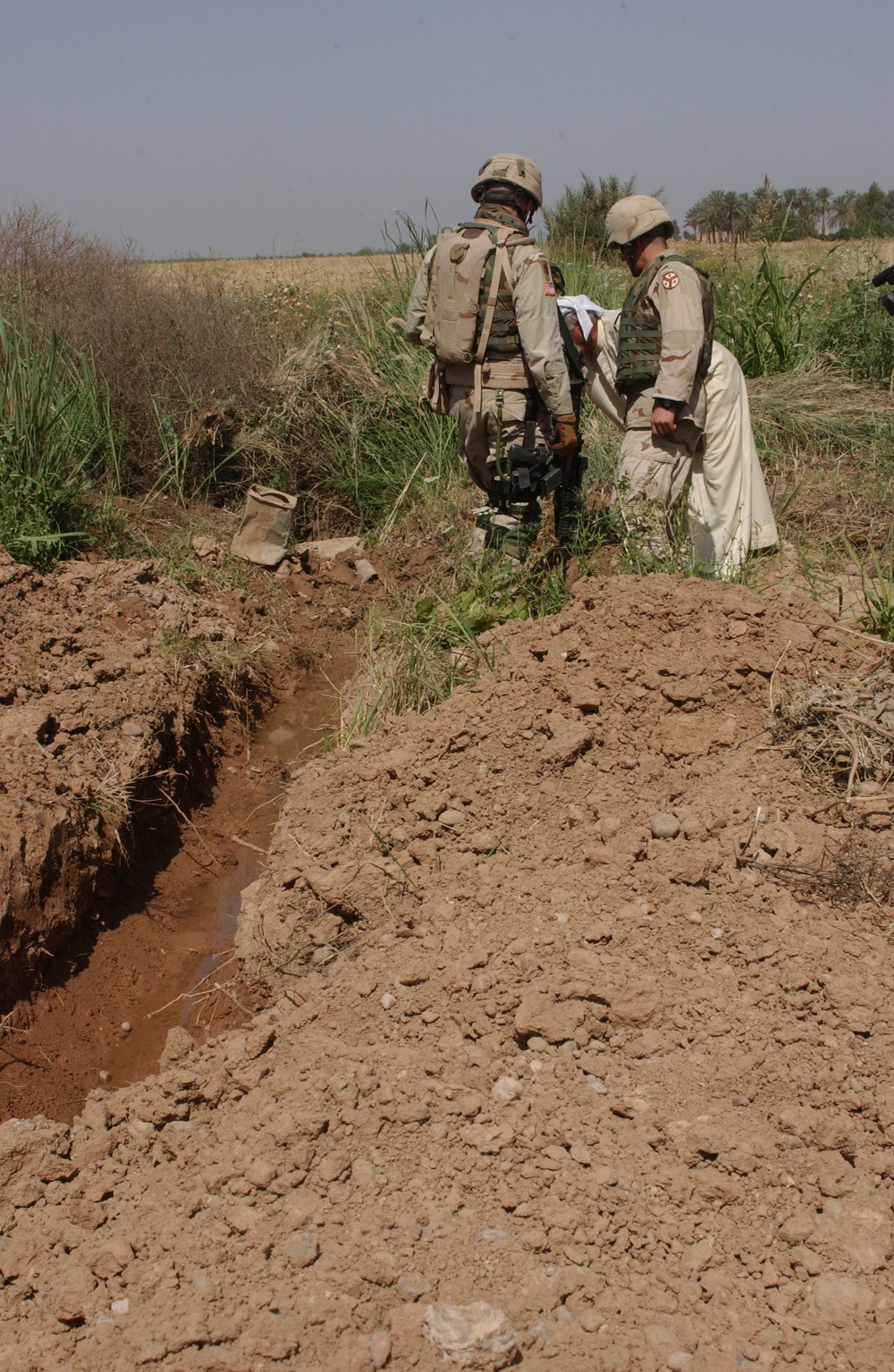 Capt. Paul Shannon inspect a trench with a city council member