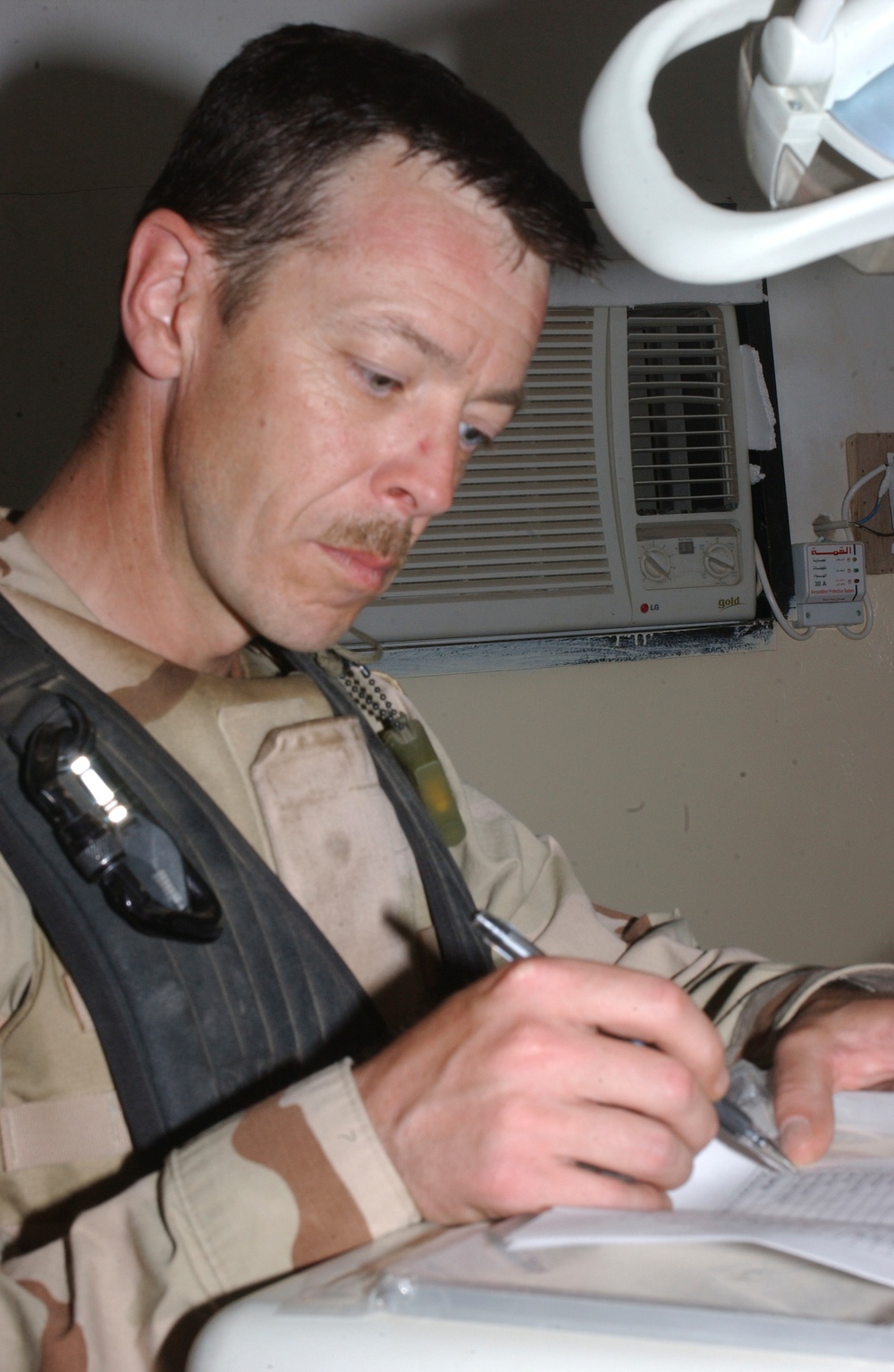 SFC Briggs check off equipment on an inventory sheet