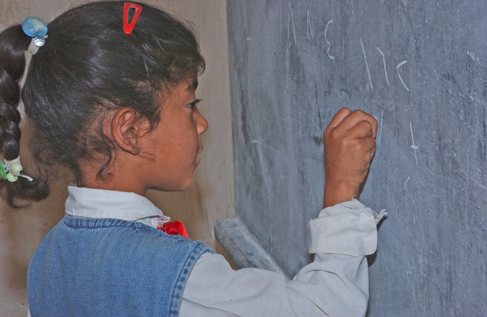 A young Iraqi girl solves a math problem