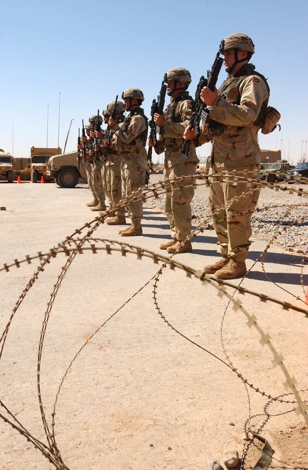 The seven-man firing party stands ready to fire