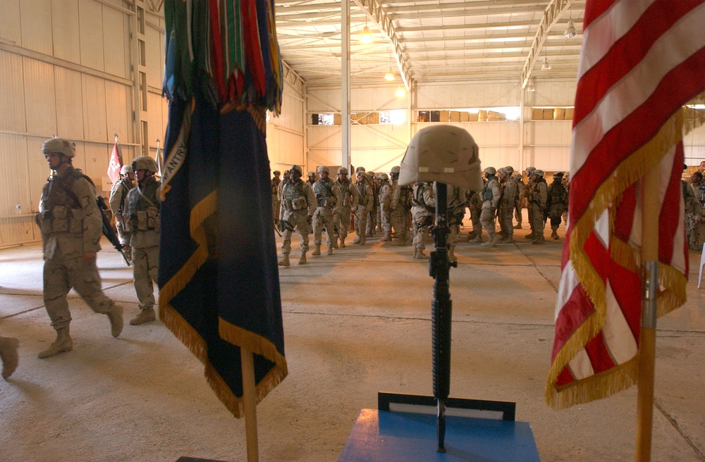 Soldiers file past a memorial of Pfc. Wesley R. Riggs