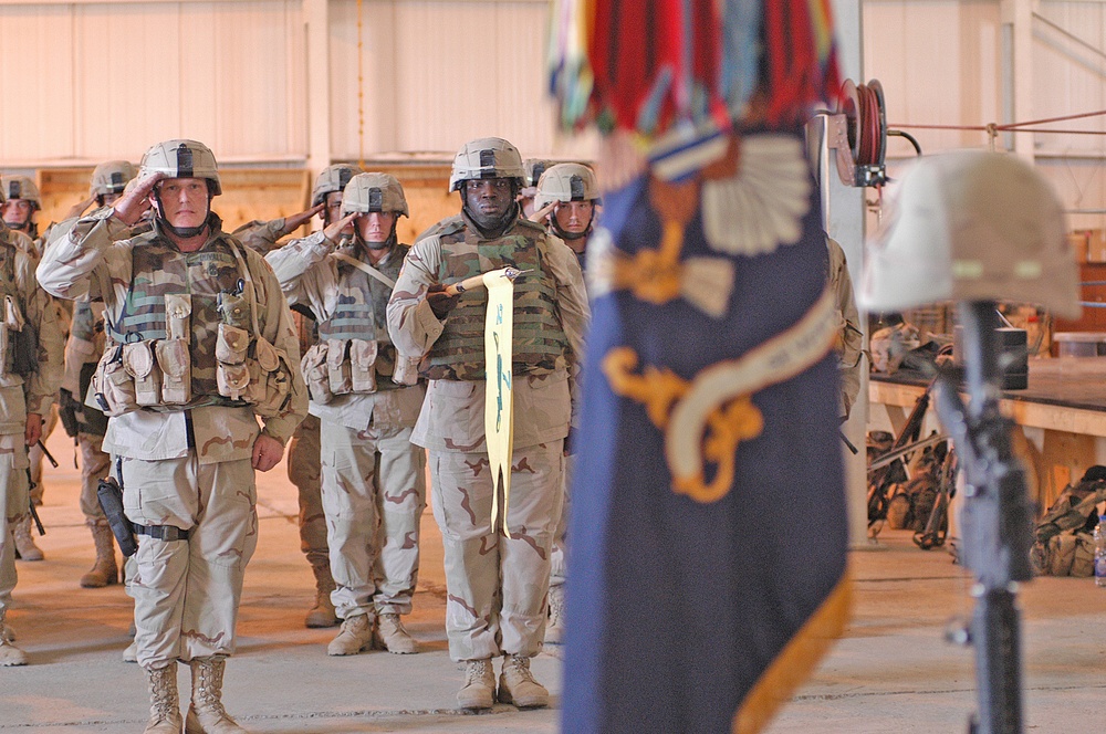 Soldiers render a final salute to a Pfc. Wesley R. Riggs