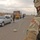 A Soldier watches as a Iraqi police search a vehicle A Soldier watches as a Iraqi police search a vehicle