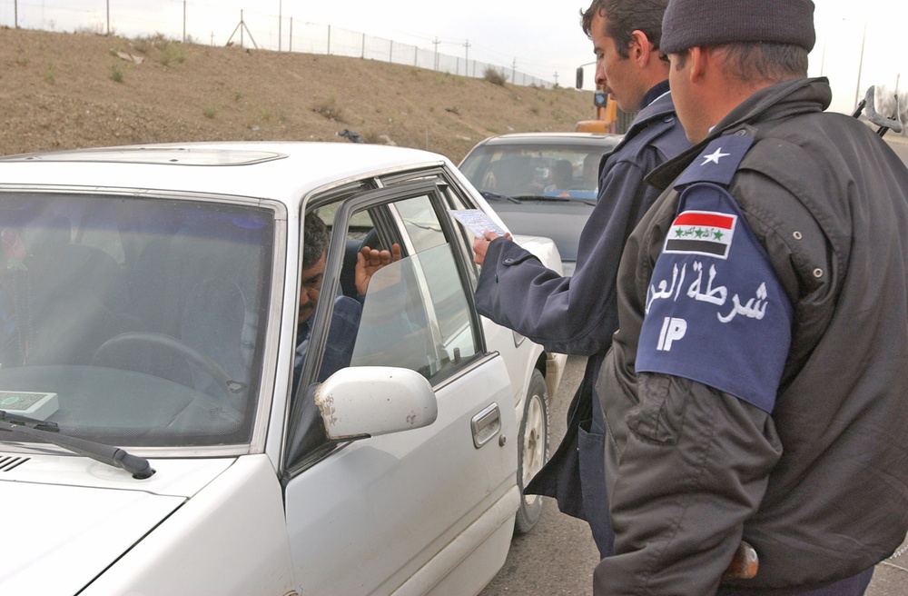 An Iraqi policeman checked the identification