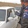 An Iraqi policeman checked the identification An Iraqi policeman checked the identification