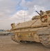 A gunner watches as an Iraqi civilian vehicle drives past