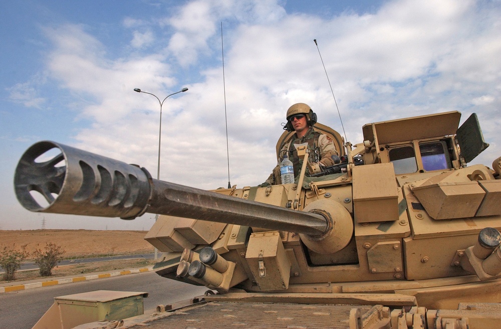 A Soldier stands guard in an M3A3 Bradley Fighting Vehicle