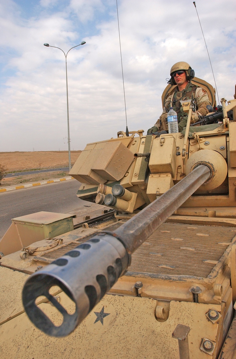 A soldier stands guard in an M3A3 Bradley Fighting Vehicle