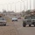 Soldiers watch traffic pass as they proceede through Soldiers watch traffic pass as they proceede through
