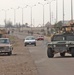 Soldiers watch traffic pass as they proceede through