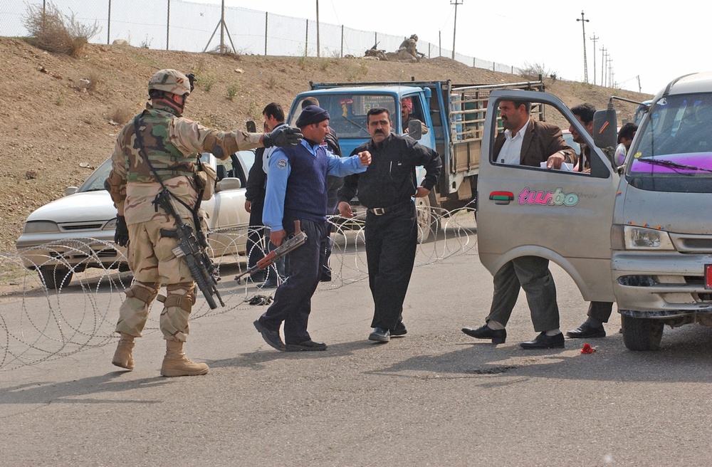 An Iraqi policeman checks the identification/registration